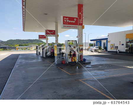 Shell petrol station during daytime. Customers come to visit this petrol station to refuel, buy groceries or use the facilities provided. 63764543