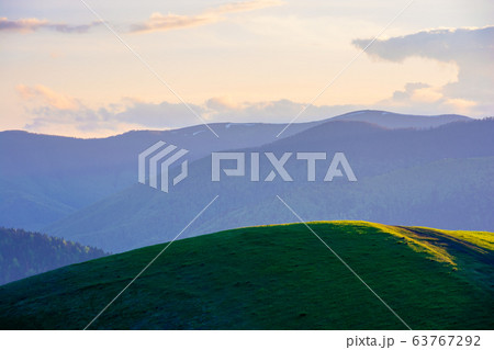 mountainous countryside in springtime at dusk. mountainous countryside in springtime at dusk. 63767292