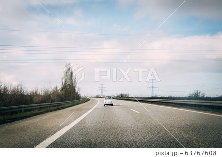 classic Fiat 500 driving on street on sunny day 63767608
