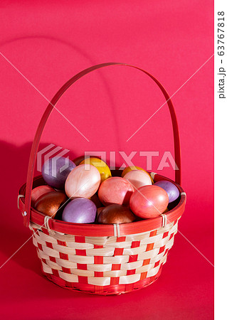 Easter eggs in basket isolated on red 63767818