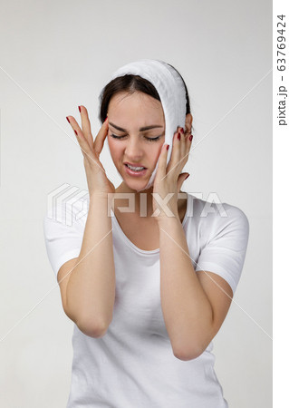 young sad woman suffering from tooth pain 63769424