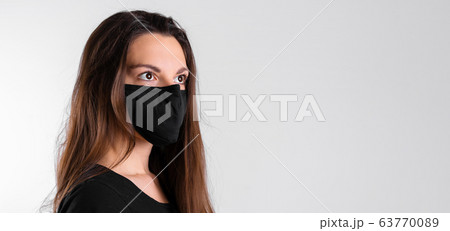 Young woman wearing black protective mask. Flu or virus pandemic. Allergy season Young woman wearing black protective mask. Flu or virus pandemic. Allergy season 63770089