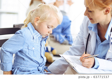 Happy smiling child patient at usual medical inspection. Doctor and patient in clinic. Medicine, healthcare concepts 63771537