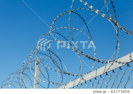 fence with barbed wire 63773856