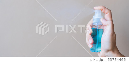 woman hand spraying alcohol sanitizer bottle woman hand spraying alcohol sanitizer bottle 63774466