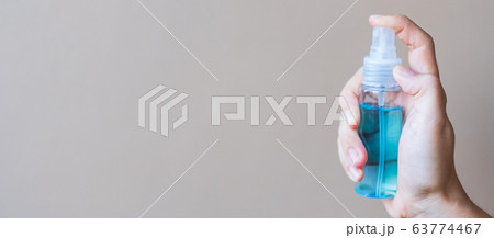 woman hand spraying alcohol sanitizer bottle woman hand spraying alcohol sanitizer bottle 63774467