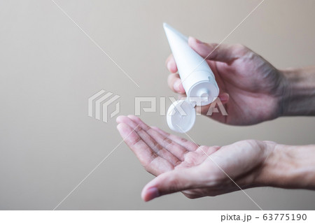 Man hands using wash hand alcohol gel or sanitizer Man hands using wash hand alcohol gel or sanitizer 63775190
