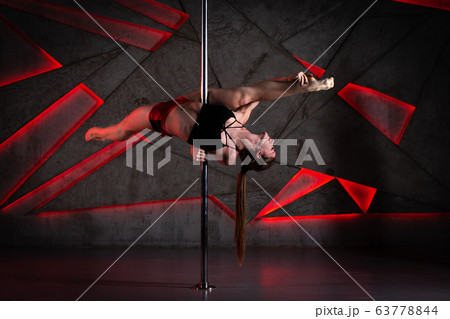 Beautiful girl dancing on the pole at studio 63778844