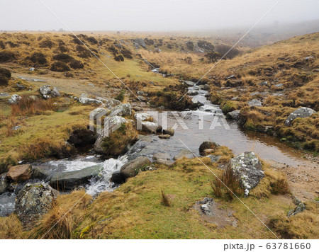 Footpath across Red-a-ven Brook as it cascades over rocks below mist and low cloud, Dartmoor National Park, Devon 63781660