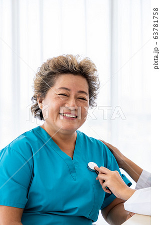 Medical doctor use stethoscope to listen to examine check senior elderly Asian female patient 63781758
