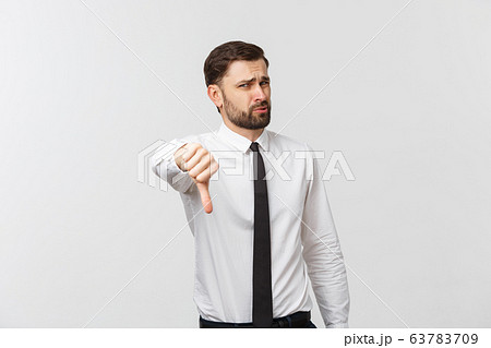Happy smiling young business man with thumbs down gesture, isolated over white background Happy smiling young business man with thumbs down gesture, isolated over white background 63783709