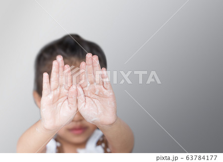 The girl was washing hands with soap. The girl was washing hands with soap. 63784177