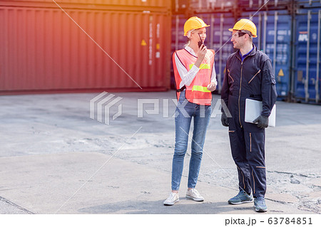 logistic worker man and woman working team with radio control loading containers at port cargo logistic worker man and woman working team with radio control loading containers at port cargo 63784851