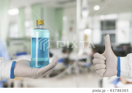 Alcohol sanitizer for cleaner sterilize and thumb up of the doctor in hospital ward. Alcohol sanitizer for cleaner sterilize and thumb up of the doctor in hospital ward. 63786365