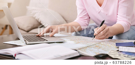 Senior woman marking infected countries on map at home 63788226