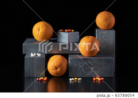 Oranges and vitamins on silver parallelepipeds on Oranges and vitamins on silver parallelepipeds on 63789054