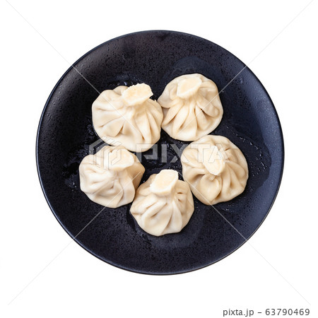 top view of five khinkali on black plate isolated 63790469