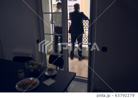 Business partners talking to each other after lunch in balcony 63792279