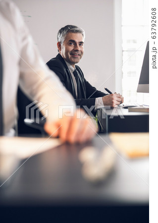 Handsome mature office worker smiling in office 63792608