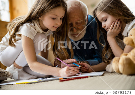 Calm kids drawing at home with grandpa stock photo Calm kids drawing at home with grandpa stock photo 63793173