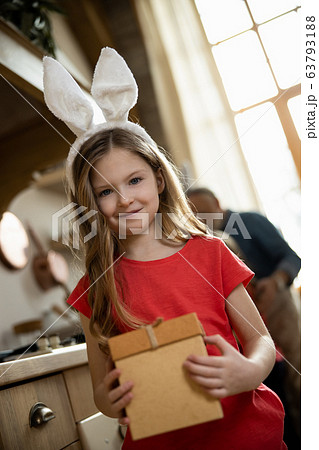 Cute girl receiving her present and smiling stock photo 63793188