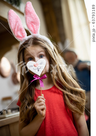 Funny child having cute gingerbread and bunny ears stock photo 63793189