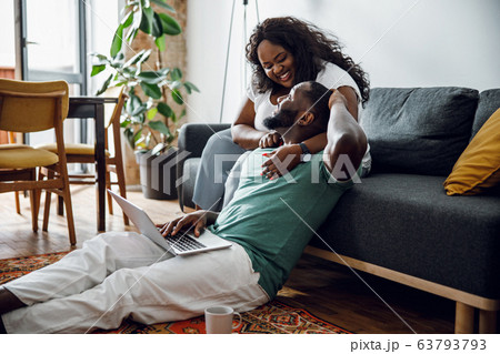 Happy woman leaning to boyfriend at home stock photo 63793793