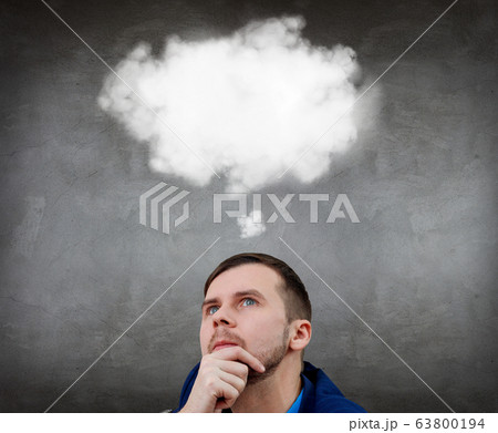 Businessman sitting on the floor with white cloud over head. 63800194