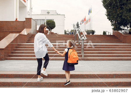 Mother prepare little daughter to school 63802907
