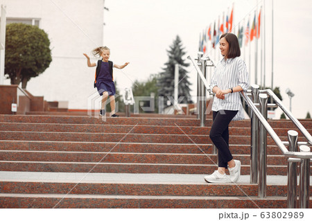 Mother prepare little daughter to school Mother prepare little daughter to school 63802989