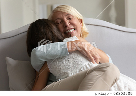 Loving senior grandmother and little granddaughter relax at home 63803509