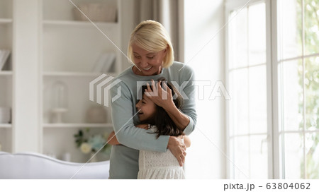 Happy granny and small granddaughter play together at home Happy granny and small granddaughter play together at home 63804062