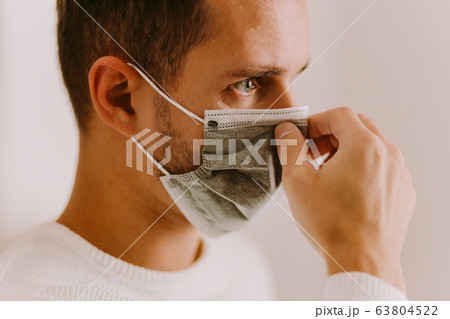 man using face mask for virus prevention measures man using face mask for virus prevention measures 63804522