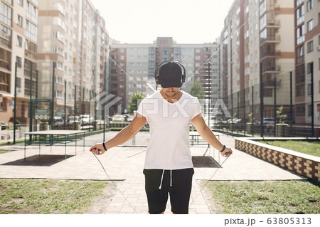 Handsome man training in a summer park 63805313