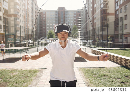 Handsome man training in a summer park Handsome man training in a summer park 63805351