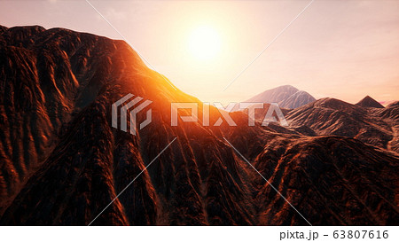 Sun Rays over Mountains in a Valley 63807616