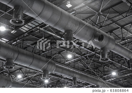 HVAC Duct Cleaning, Ventilation pipes in silver insulation material hanging from the ceiling inside new building. 63808864