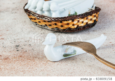 Antique porcelain duck cutlery stand on concrete Antique porcelain duck cutlery stand on concrete 63809158