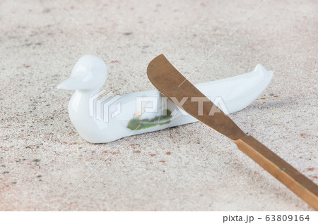Antique porcelain duck cutlery stand on concrete 63809164