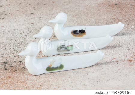 Antique porcelain duck cutlery stand on concrete 63809166