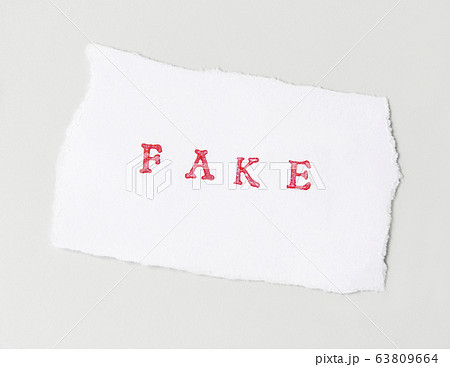 Word Fake  written on torn paper 63809664