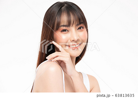 Young Beautiful Asian woman smile touching soft cheek Young Beautiful Asian woman smile touching soft cheek 63813635