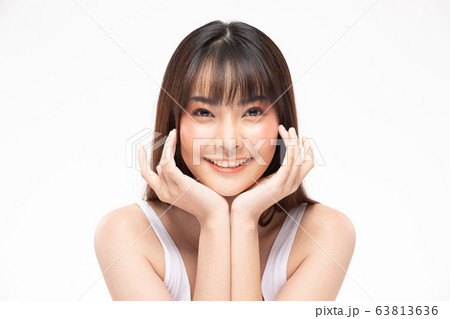 Young Beautiful Asian woman smile touching soft cheek  63813636