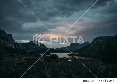 mountain lake in moody atmosphere after sunset 63814361