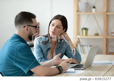 Diverse colleagues brainstorm using laptop at meeting 63815277