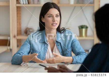 Confident young woman speak at office meeting 63815374