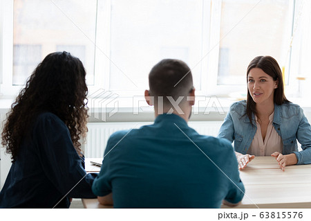 Diverse recruiters interview female job candidate in office Diverse recruiters interview female job candidate in office 63815576
