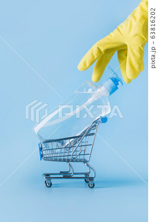 Yellow gloved hand reaches for trolley cart  63816202