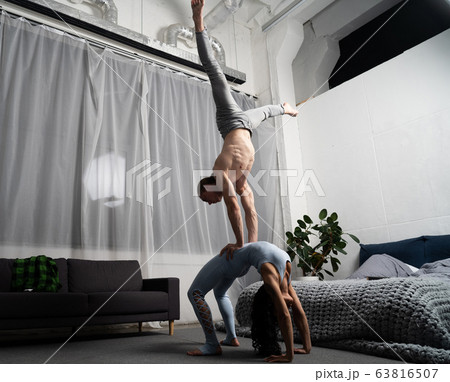 romantic couple making acrobatic trick in the bedroom romantic couple making acrobatic trick in the bedroom 63816507