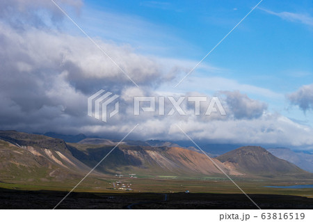 Icelandic landscape with mountains, blue sky and green grass on the foreground. West fjord part Icelandic landscape with mountains, blue sky and green grass on the foreground. West fjord part 63816519